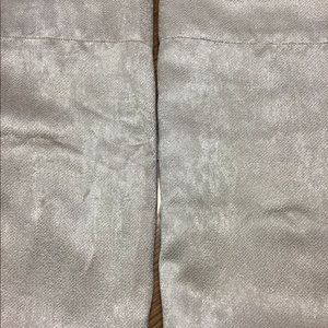 Drapes a pair (2 total ) of cream colored drapes